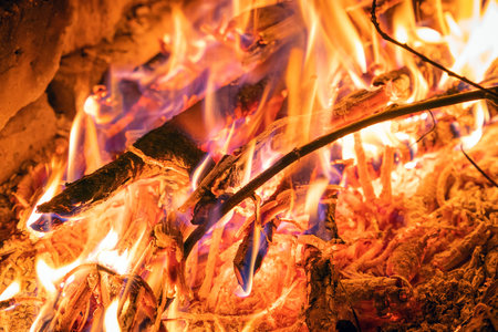 Bright flame of a burning fire in the dark.