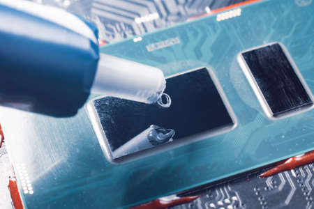 Applying thermal paste to a laptop processor, cooling computer components.の写真素材