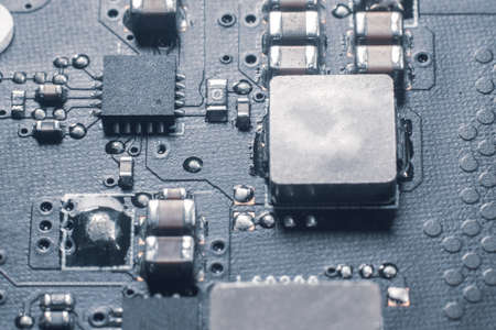Laptop motherboard close up with resistors transistors.