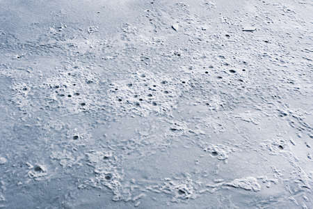 Frozen ice surface of a lake in winter, background texture.の写真素材