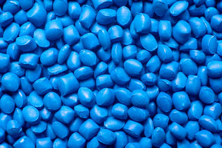 Blue polymer dye in granules, background texture.