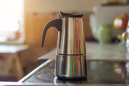 Geyser coffee maker on an electric stove in the kitchen in the morning.の写真素材