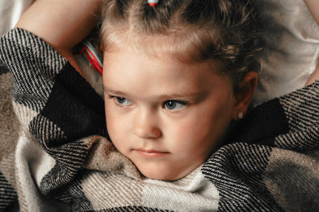 Portrait of cute adorable smiling little girl waking up in her bed.