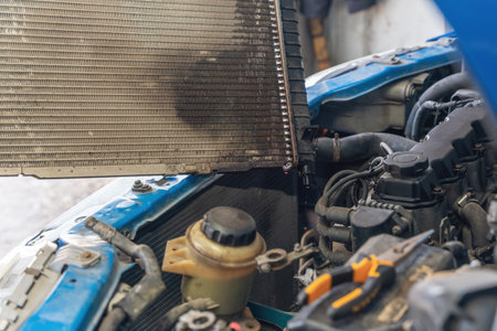 A man replaces an old broken radiator in a car with a new one.の写真素材