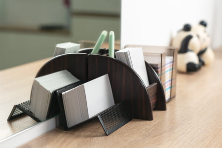 Stack of business cards on a stand.の写真素材