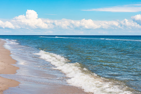 Beautiful sandy seashore with blue sky and clouds.の写真素材