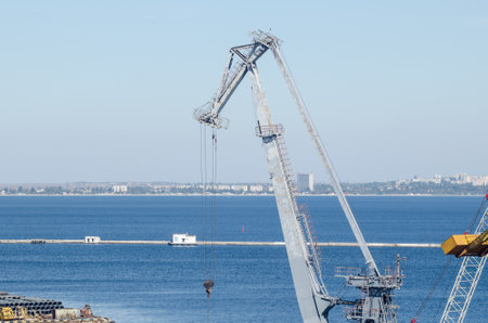 Industrial port crane boom in sea cargo port.