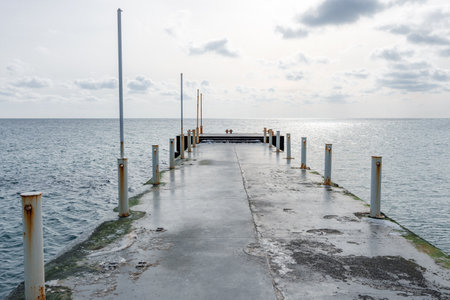 Empty concrete pier by the winter sea on a sunny day.の写真素材