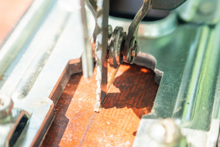 A carpenter cuts a board with an electric jigsaw.
