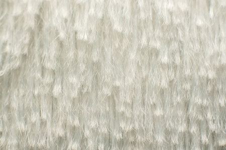 White soft fabric with long pile in macro for abstract backgrounds and textural solutions.