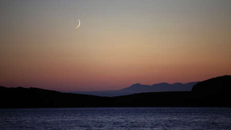 Sea landscape with mountains and a moon