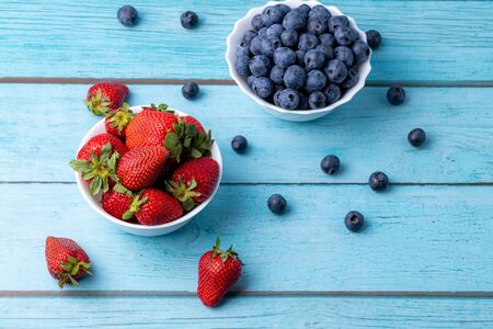Berries, summer fruits on a wooden table. Healthy lifestyle concept.の写真素材