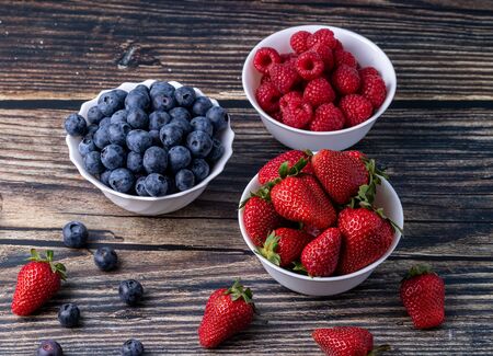 Berries, summer fruits on a wooden table. Healthy lifestyle concept. Selective focusの写真素材