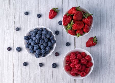 Berries, summer fruits on a wooden table. Healthy lifestyle concept.の写真素材