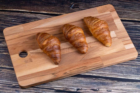 Croissants on a wooden board.の写真素材