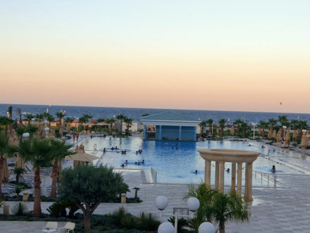 August 26, 2017. Concorde Green Park Palace, Rue Morjan B.P. Box 95 Port, Hammam Sousse, Tunisia A cafe near a hotel with an oriental-style pool, among palm trees and greenery on the seashore with a beautiful sunset in Tunisiaのeditorial素材