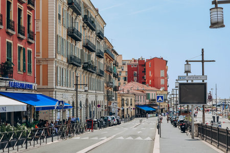 Nice, France - 01 June 2023: View of the port of Nice, moored yachts and boats, and the brightly colored facades of the surrounding housesのeditorial素材