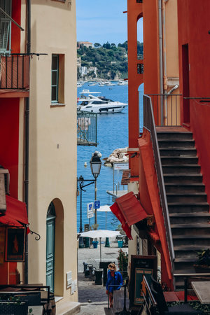 Villefranche sur Mer, France - 01 June 2023: Beautiful bright orange and red facades in the city center of Villefranche sur Mer, on the French Rivieraのeditorial素材