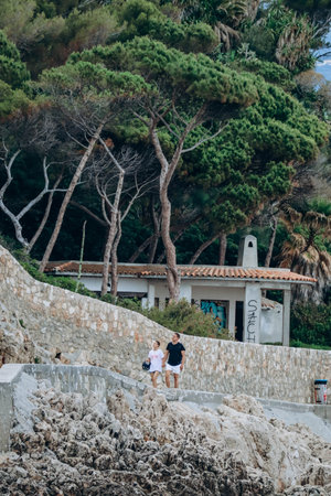 Saint-Jean-Cap-Ferrat, France - 01 June 2023: A couple of people walking along Cap Ferratのeditorial素材