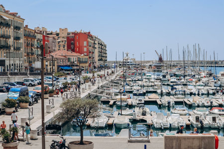 Nice, France - 01 June 2023: View of the port of Nice, moored yachts and boats, and the brightly colored facades of the surrounding housesのeditorial素材