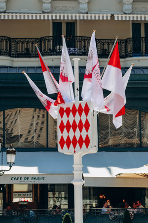 Monaco, Monaco - 25 June 2023: Coat of arms of Monaco, as well as flags in honor of the 100th anniversary of Prince Rainier IIIのeditorial素材