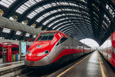 Milan, Italy - 2 January 2024: Two symmetrically situated FrecciaRossa trains at a station in Milanのeditorial素材