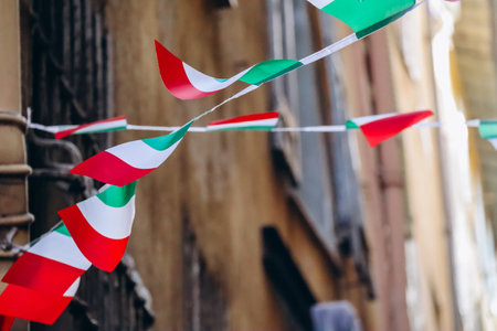Waving Italian flags on the street of the old townの写真素材