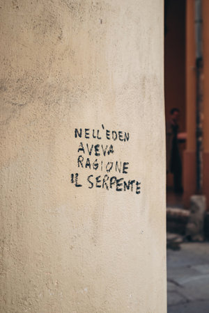 Bologna, Italy - October 6, 2024: Writing on the wall in Bologna: "In Eden the serpent was right"のeditorial素材