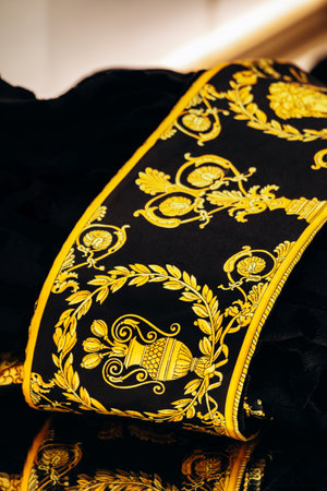 Bologna, Italy - October 6, 2024: A robe with Versace embroidery in a boutique windowのeditorial素材
