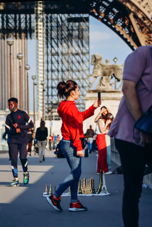 Paris, France - 15 July 2021: People taking photos near the base of the Eiffel Towerのeditorial素材