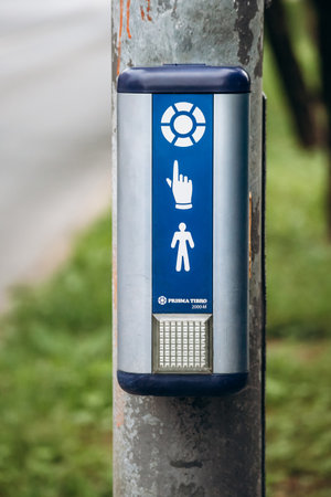 Pedestrian button to signal waiting and switch traffic light