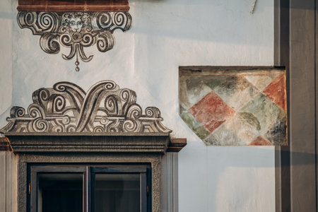 The facade of an old building in the very center of Ljubljana, showing a fragment of the historical facade and paintingsの写真素材
