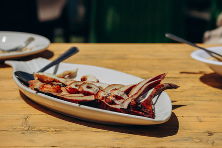 Fried squid on an outstretched plateの写真素材