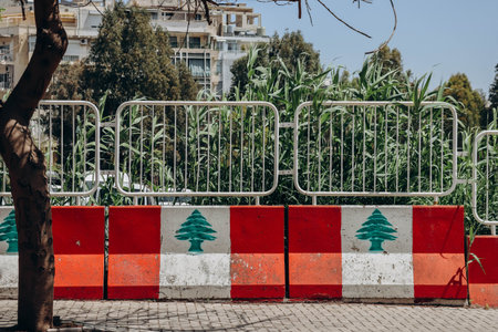 The Lebanese flag displayed on a concrete fence in the center of Beirutの写真素材