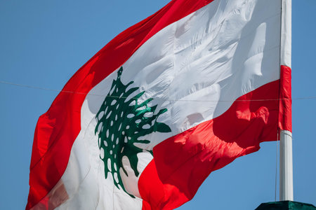 The Lebanese flag in the center of Beirut fluttering in the wind, close-upの写真素材