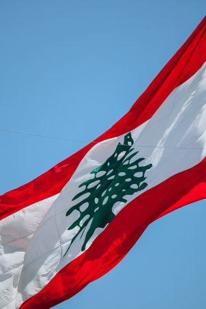The Lebanese flag in the center of Beirut fluttering in the wind, close-upの写真素材