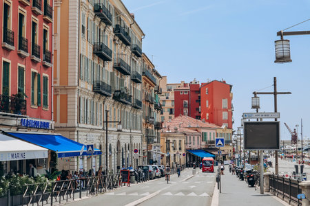 Nice, France - 01 June 2023: View of the port of Nice, moored yachts and boats, and the brightly colored facades of the surrounding housesのeditorial素材