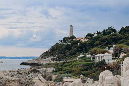 View of the lighthouse on the peninsula of Saint Jean Cap Ferrat in cloudy weather, on the French Rivieraの写真素材