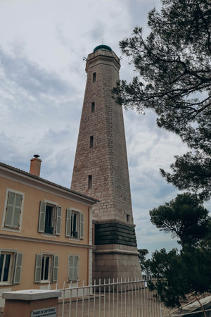 View of the lighthouse on the peninsula of Saint Jean Cap Ferrat in cloudy weather, on the French Rivieraの写真素材