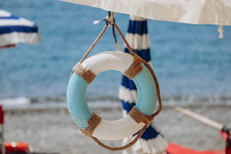 Decorative lifebuoy on the beach in Italy, on the Italian Rivieraの写真素材
