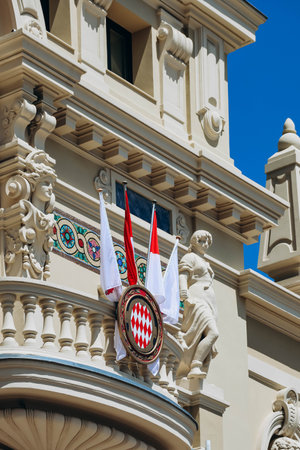 Monaco, Monaco - 25 June 2023: Coat of arms of Monaco, as well as flags in honor of the 100th anniversary of Prince Rainier IIIのeditorial素材