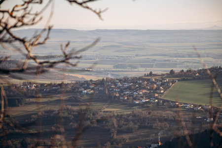 View from Plateau de Gergovie to Clermont-Ferrand suburbs on a winter sunsetの写真素材