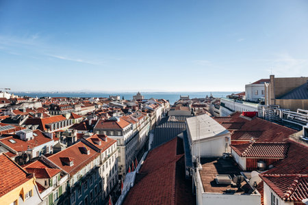 View of Lisbon from the famous Santa Justa viewpoint, showcasing the city's rooftops and historic landmarksの写真素材