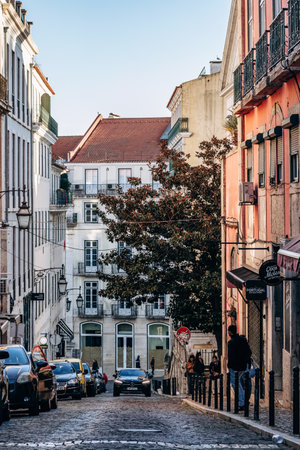 Lisbon, Portugal - January 2, 2025: View of an old street in central Lisbon at sunset