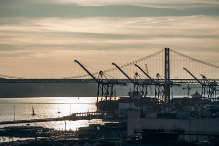 Lisbon, Portugal - January 2, 2025: A beautiful view of the iconic 25 de Abril Bridge in Lisbon, Portugal, seen from the Miradouro de Santa Catarina viewpoint.の写真素材