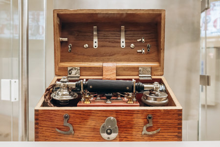 Lisbon, Portugal - January 2, 2025: An antique telegraph machine displayed in a wooden box,...