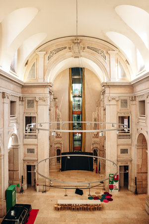 Lisbon, Portugal - January 2, 2025: A view of the grand interior of the Money Museum, featuring elegant architectural details and a modern hanging exhibit in the center.のeditorial素材