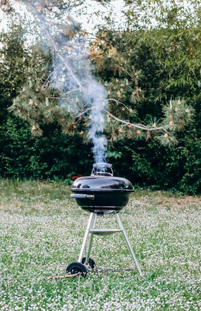 Closed charcoal barbecue grill in the gardenの写真素材