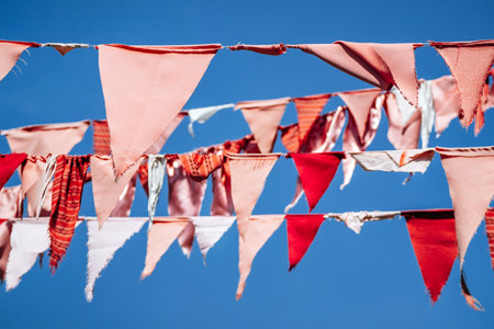 Colorful flags hanging in the Metelkova area of Ljubljanaの写真素材