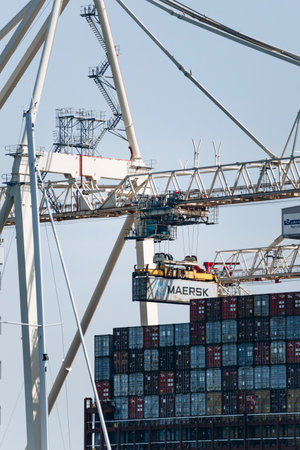 Koper, Slovenia - August 16, 2024: Cargo containers being loaded in the Port of Koper during the day